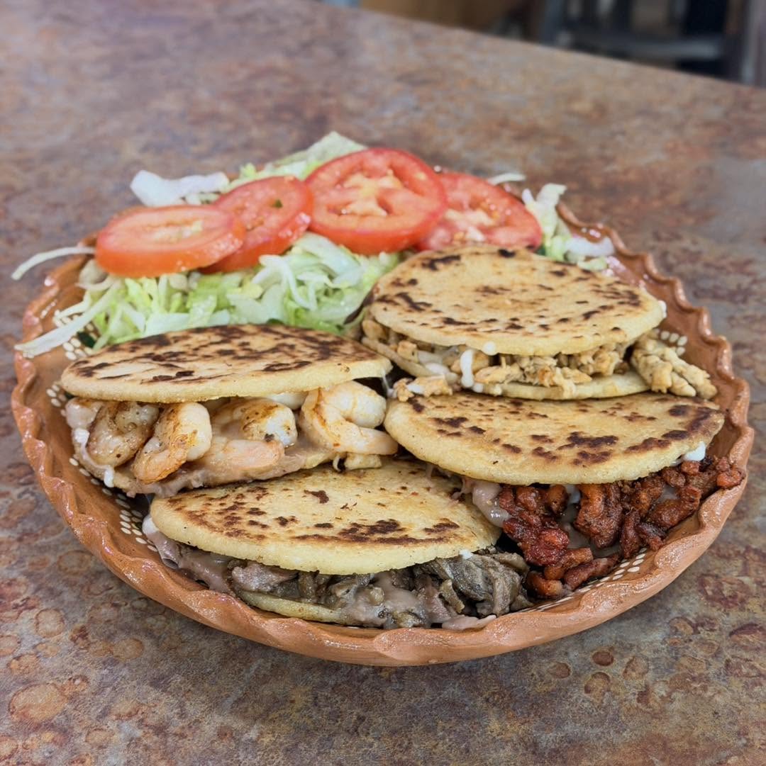 Handmade corn gordita split open and stuffed with seasoned beef, cheese, and beans.